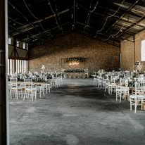 The hall at Annerkant Venue set with round tables and chiavari chairs