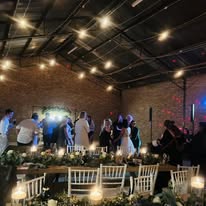 Guests dancing in the hall under warm lighting