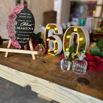 Table detail with illuminated 60th birthday letters and signage